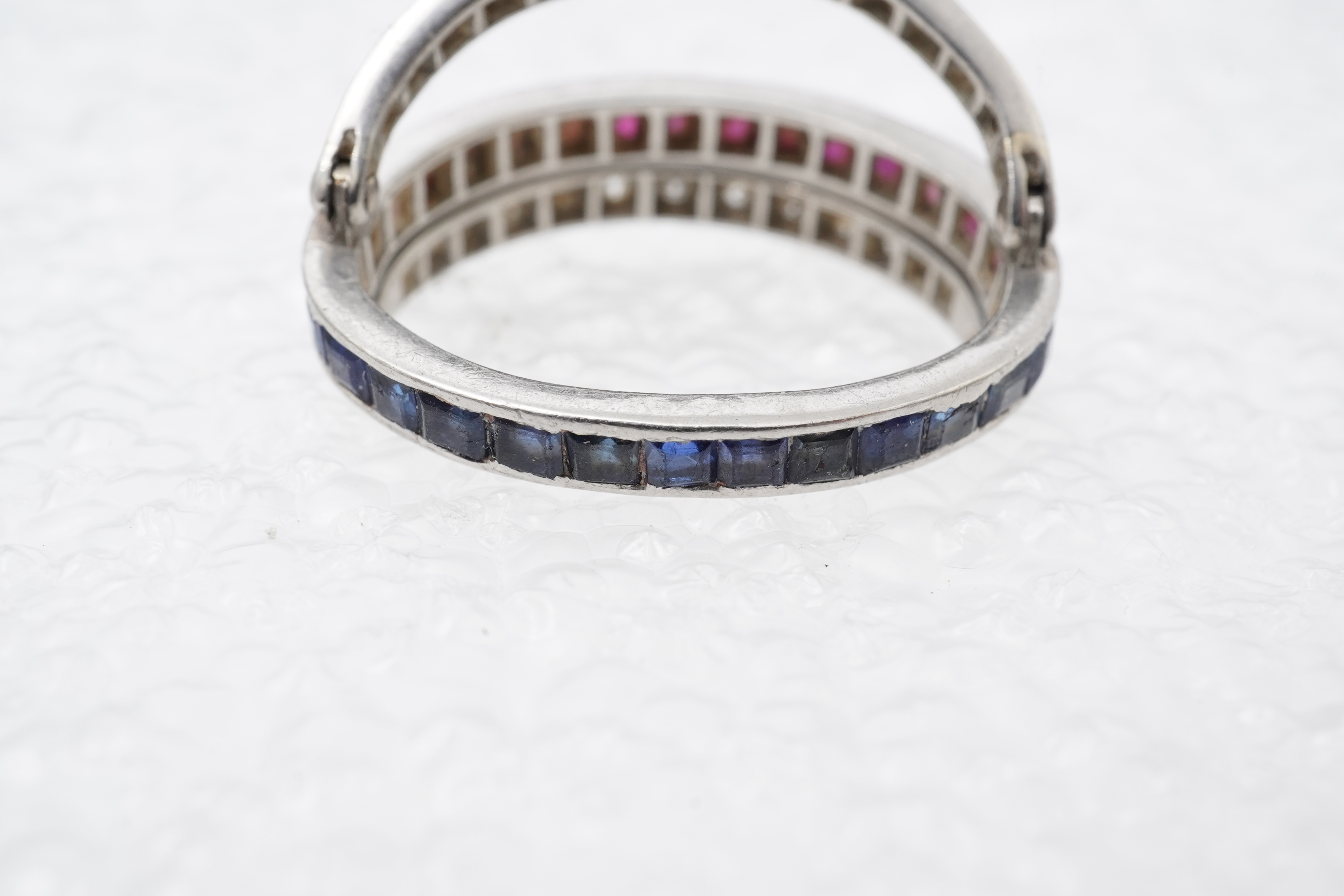 A ruby, sapphire and diamond 'Day and Night' ring, mid 20th century